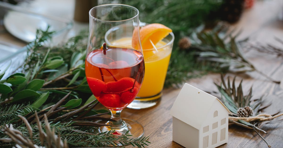 How to conserve natural fruit juices without alcohol? - Glasses of tasty cocktails and herbs on table How to conserve natural fruit juices without alcohol? - Glasses of tasty cocktails and herbs on table