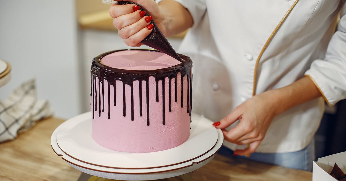 How to convert a chocolate fudge frosting recipe to white chocolate? - Anonymous female pastry chef in white uniform standing near counter and preparing yummy cake with chocolate drips from pastry bag in kitchen How to convert a chocolate fudge frosting recipe to white chocolate? - Anonymous female pastry chef in white uniform standing near counter and preparing yummy cake with chocolate drips from pastry bag in kitchen