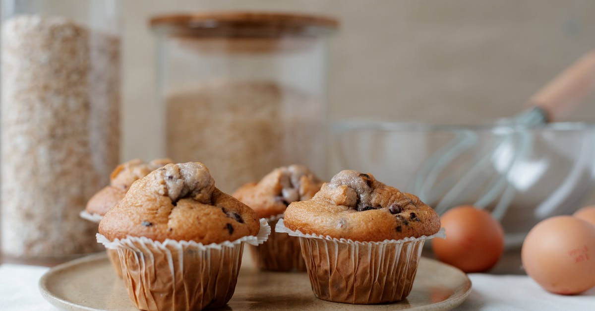 How to convert a muffin/cupcake recipe to a large muffin recipe - Yummy homemade muffins near ingredients on table How to convert a muffin/cupcake recipe to a large muffin recipe - Yummy homemade muffins near ingredients on table
