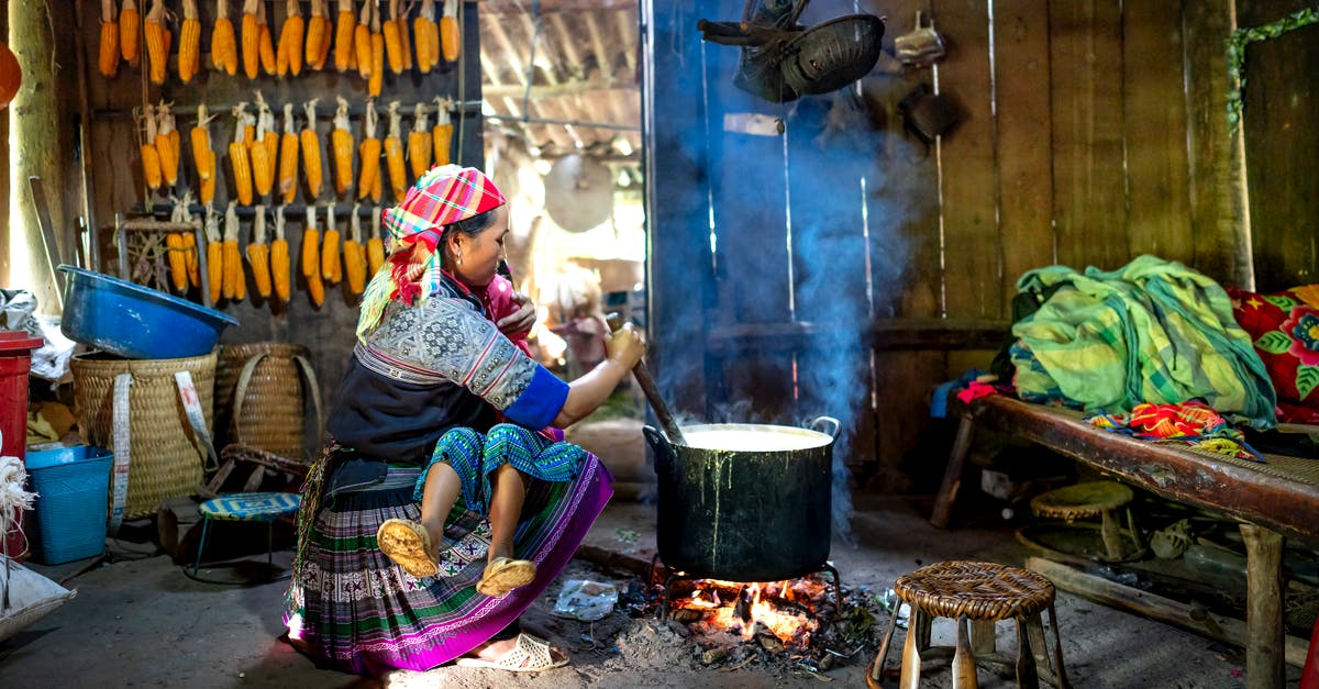 How to cook Mixed grains all together in one pot - Ethnic mother with unrecognizable daughter stirring food in cauldron indoors How to cook Mixed grains all together in one pot - Ethnic mother with unrecognizable daughter stirring food in cauldron indoors
