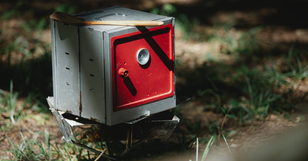 how to cook on a low and high oven - Folding camping oven placed in forest in sunlight how to cook on a low and high oven - Folding camping oven placed in forest in sunlight