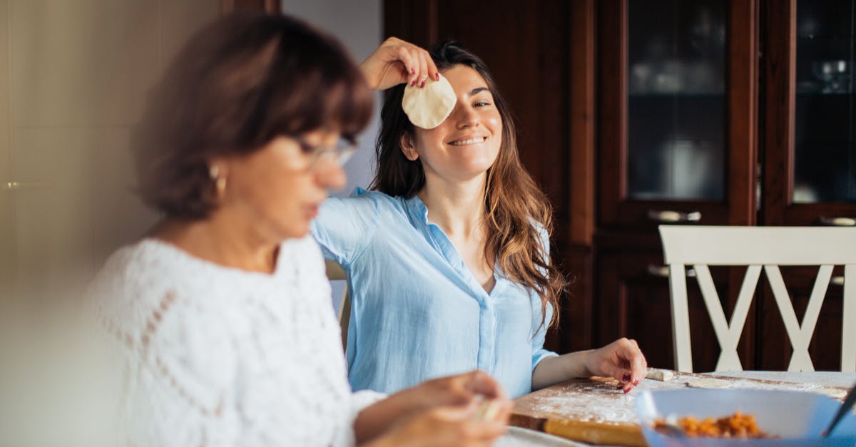 How to cook pelmeni in the microwave? - Woman In Blue Top Holding A Dough