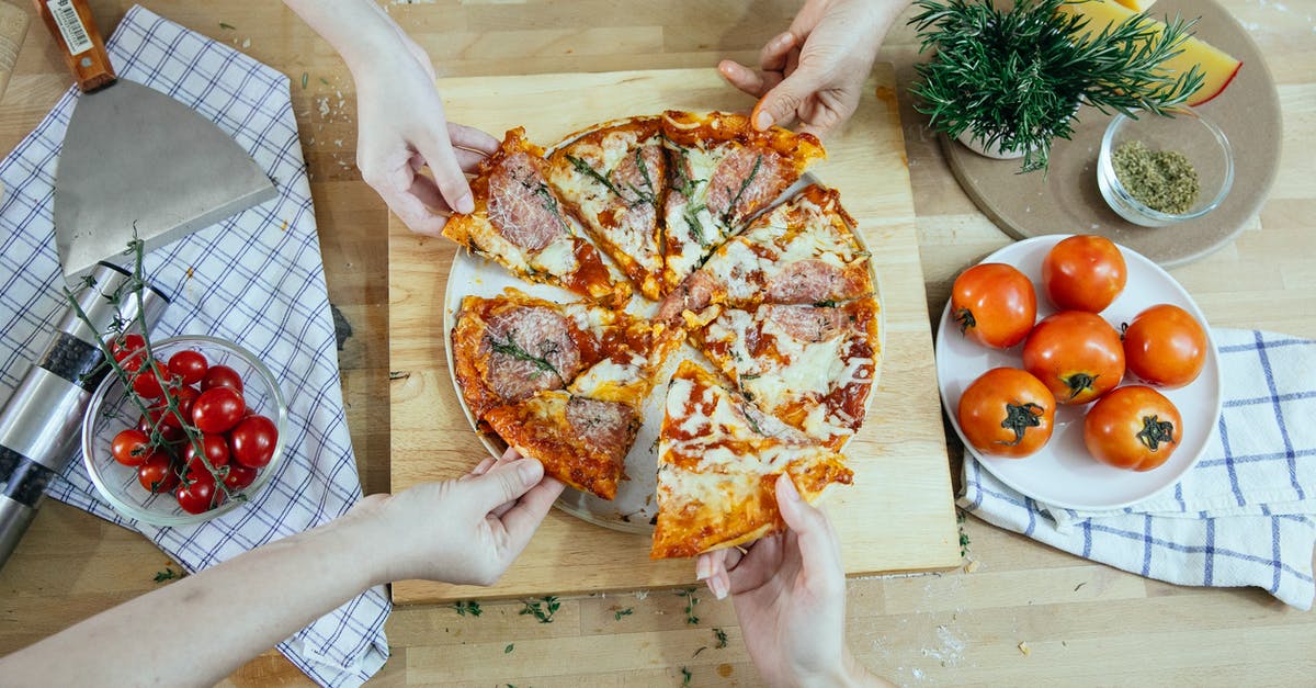 How to cook sausage? - From above unrecognizable people taking slices of pizza with salami melted cheese and herbs from plate on kitchen table How to cook sausage? - From above unrecognizable people taking slices of pizza with salami melted cheese and herbs from plate on kitchen table