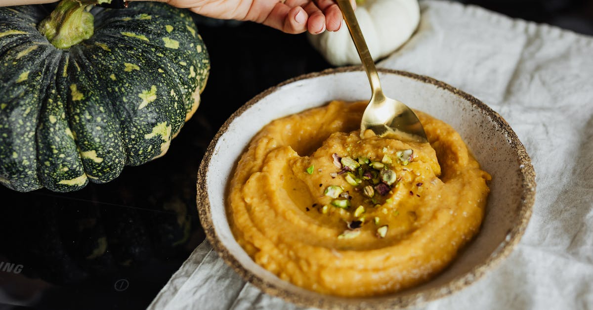How to correctly infuse cream into vegetables - Hand Holding Spoon in Bowl with Food How to correctly infuse cream into vegetables - Hand Holding Spoon in Bowl with Food