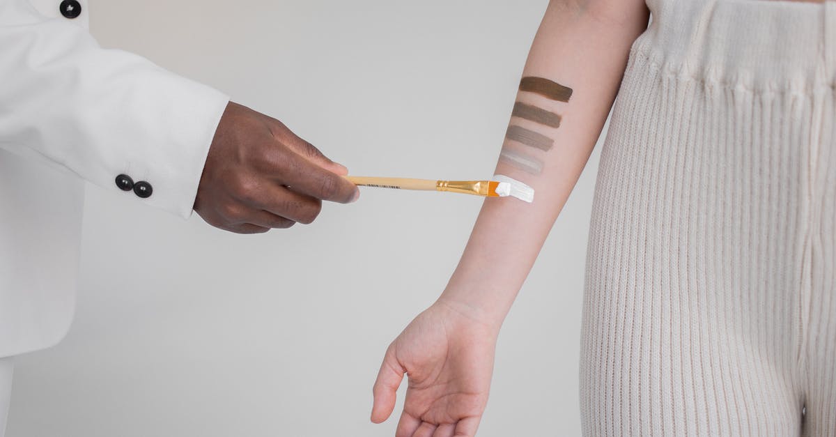 how to create gratin with _thin_ cheese skin - Black man painting stripes on hand of woman how to create gratin with _thin_ cheese skin - Black man painting stripes on hand of woman