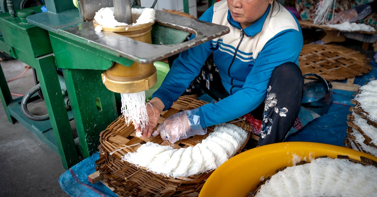 How to create the best veg noodles? - Ethnic woman making noodle in manufacture How to create the best veg noodles? - Ethnic woman making noodle in manufacture