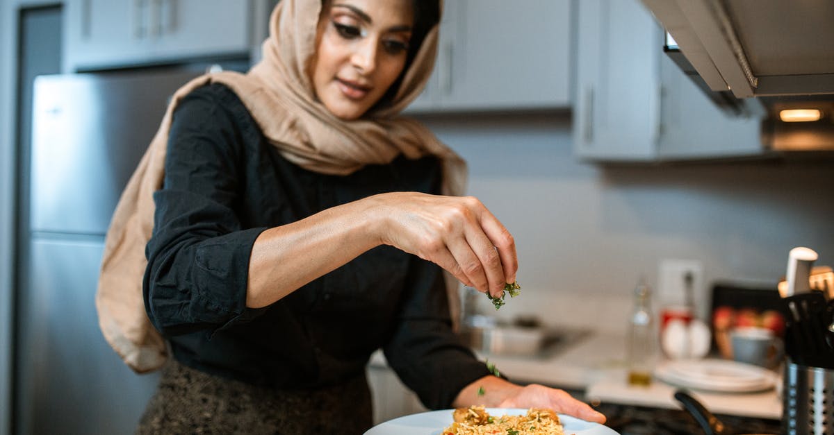 How to defrost coriander / cilantro? - A Woman Garnishing Her Rice and Meatballs Dish How to defrost coriander / cilantro? - A Woman Garnishing Her Rice and Meatballs Dish