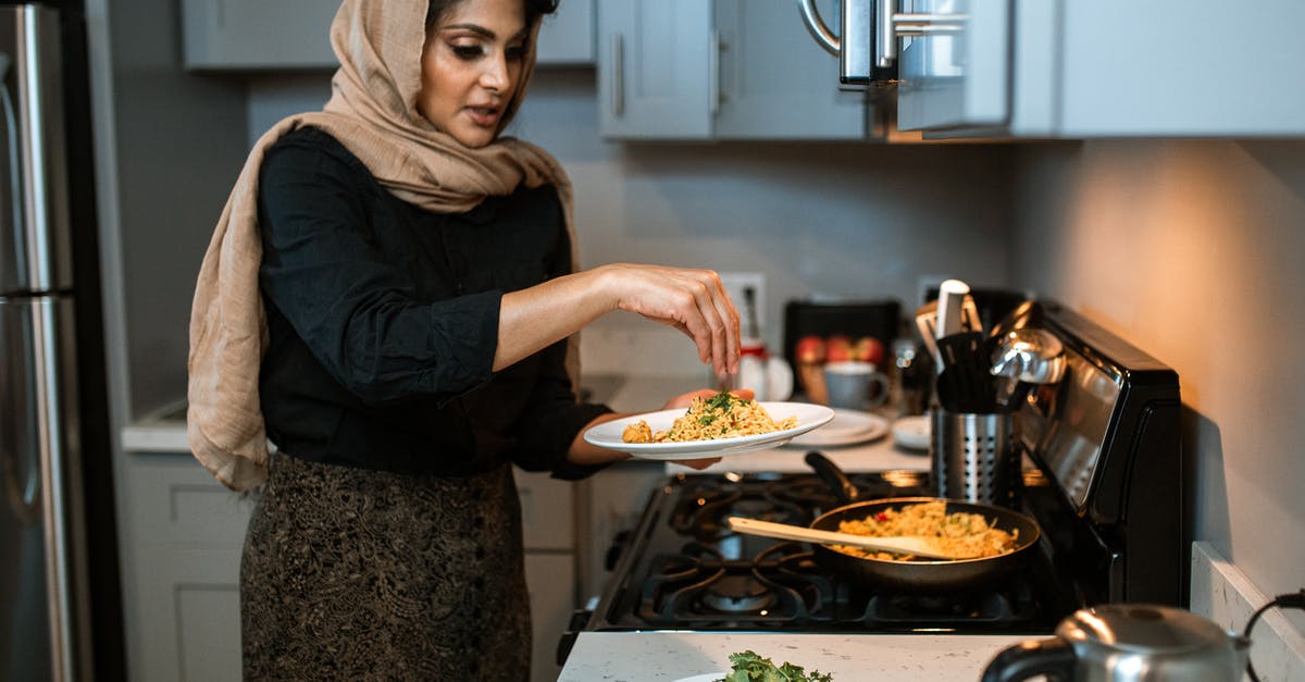 How to defrost coriander / cilantro? - A Woman Garnishing Her Rice and Meatballs Dish How to defrost coriander / cilantro? - A Woman Garnishing Her Rice and Meatballs Dish