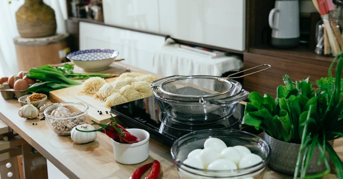 How to dehydrate chili at home? - Table with spices chopping board with noodles and bowls in kitchen How to dehydrate chili at home? - Table with spices chopping board with noodles and bowls in kitchen