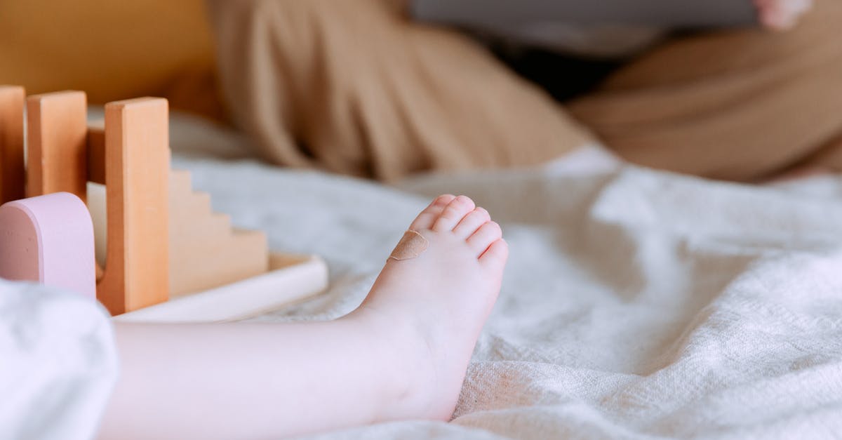 How to determine amount of mother starter to use to build a levain for STIFF/dry sourdough starter? - Crop faceless toddler sitting on bed with colorful wooden building blocks while mother sitting with legs crossed doing remote work with laptop on knees on background How to determine amount of mother starter to use to build a levain for STIFF/dry sourdough starter? - Crop faceless toddler sitting on bed with colorful wooden building blocks while mother sitting with legs crossed doing remote work with laptop on knees on background