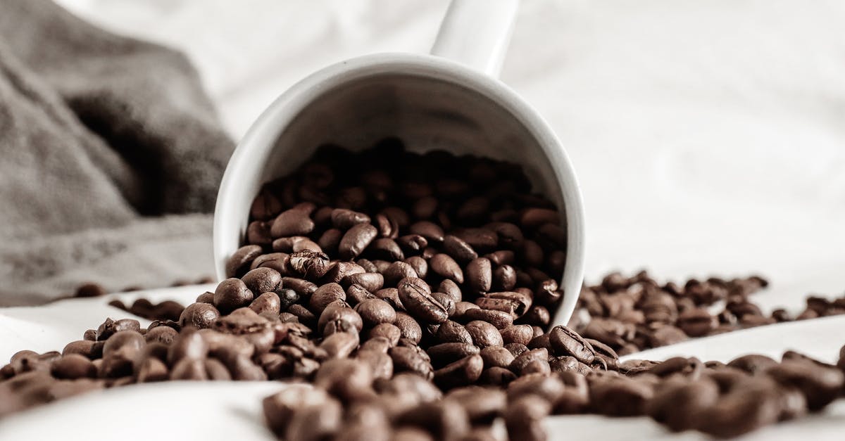 How to determine the grain of a fresh/ uncooked Arm Roast - Aromatic coffee grains scattered on white cloth from fallen ceramic cup against plaid How to determine the grain of a fresh/ uncooked Arm Roast - Aromatic coffee grains scattered on white cloth from fallen ceramic cup against plaid