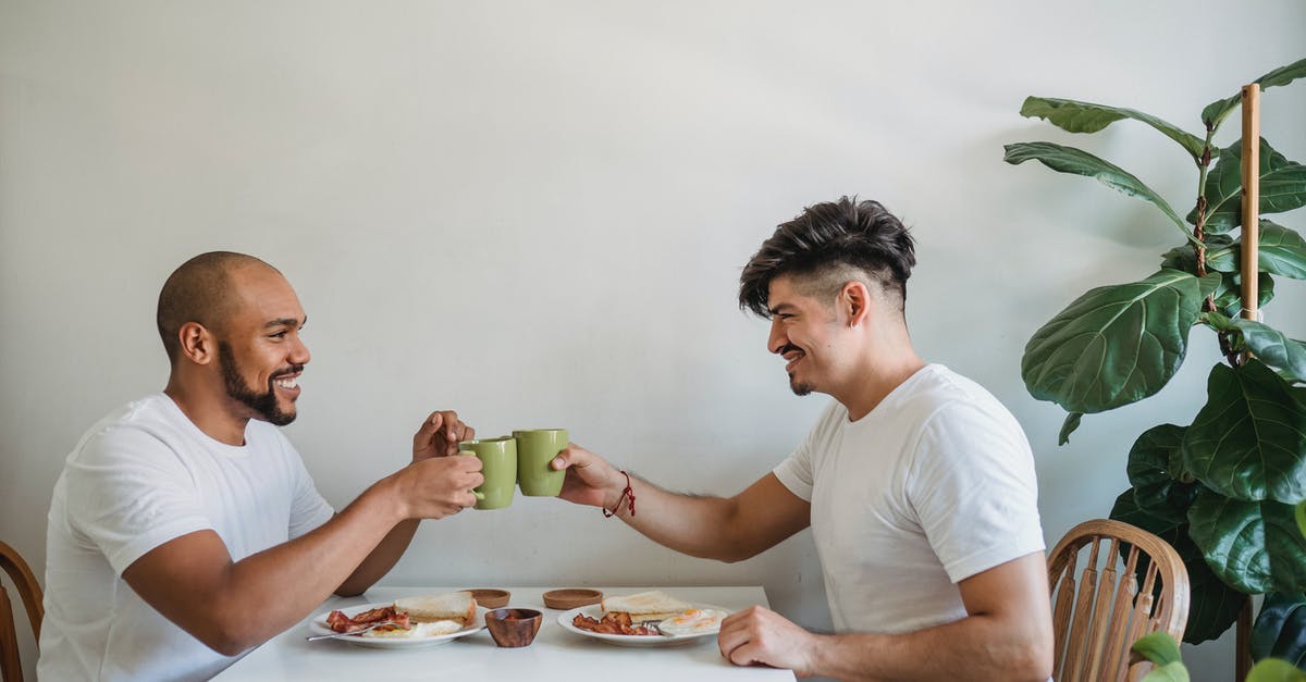 How to do English breakfast at home - Men Making Cheers with Coffee Mugs How to do English breakfast at home - Men Making Cheers with Coffee Mugs