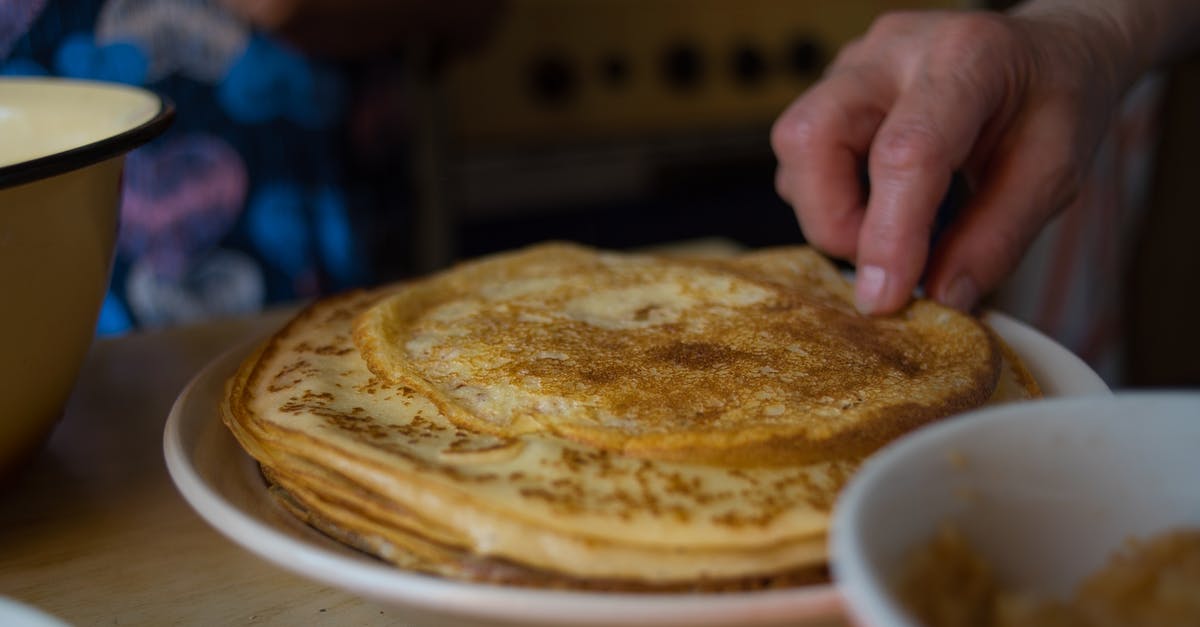 How to ensure that the Pancakes get cooked evenly? - A Person Getting a Pancake on a Plate How to ensure that the Pancakes get cooked evenly? - A Person Getting a Pancake on a Plate