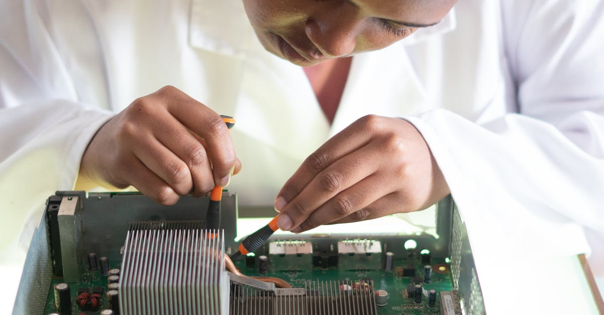 How to fix a bitter jam? (Or use it?) - Concentrated African American technician wearing lab coat and conducting expertise of motherboard by using screwdrivers while working in service center How to fix a bitter jam? (Or use it?) - Concentrated African American technician wearing lab coat and conducting expertise of motherboard by using screwdrivers while working in service center