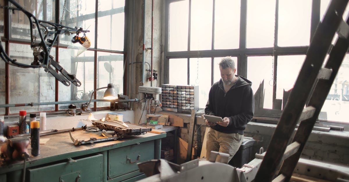 How to fix a bitter jam? (Or use it?) - Adult bearded mechanic in casual wear standing near window in workshop and browsing digital tablet How to fix a bitter jam? (Or use it?) - Adult bearded mechanic in casual wear standing near window in workshop and browsing digital tablet