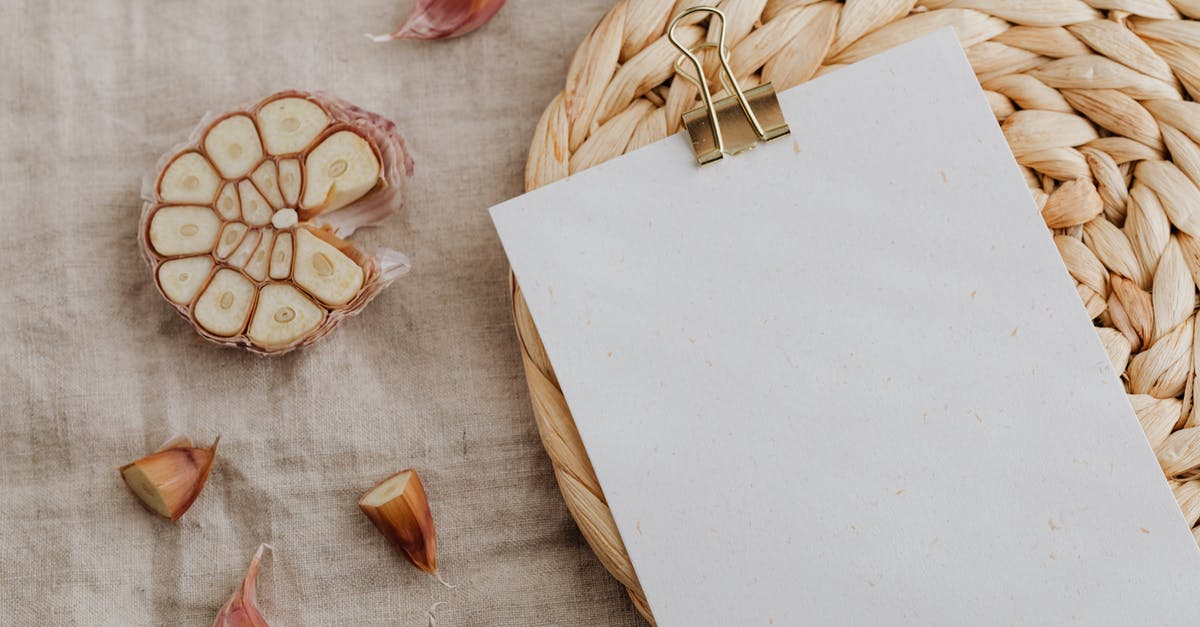 How to fix food that got extra salty? - Sheet of empty paper with clip put near halved garlic cloves How to fix food that got extra salty? - Sheet of empty paper with clip put near halved garlic cloves
