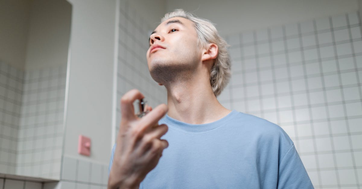 How to get a good fragrance from burnt rosemary? - Man in Blue Crew Neck T-shirt Applying Perfume How to get a good fragrance from burnt rosemary? - Man in Blue Crew Neck T-shirt Applying Perfume