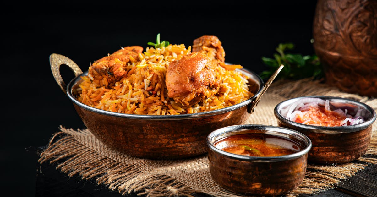 How to get all the rice out of the pan? - From above of delicious pilaf with rice and meat in iron pan served on table near traditional oriental soups in bowl How to get all the rice out of the pan? - From above of delicious pilaf with rice and meat in iron pan served on table near traditional oriental soups in bowl
