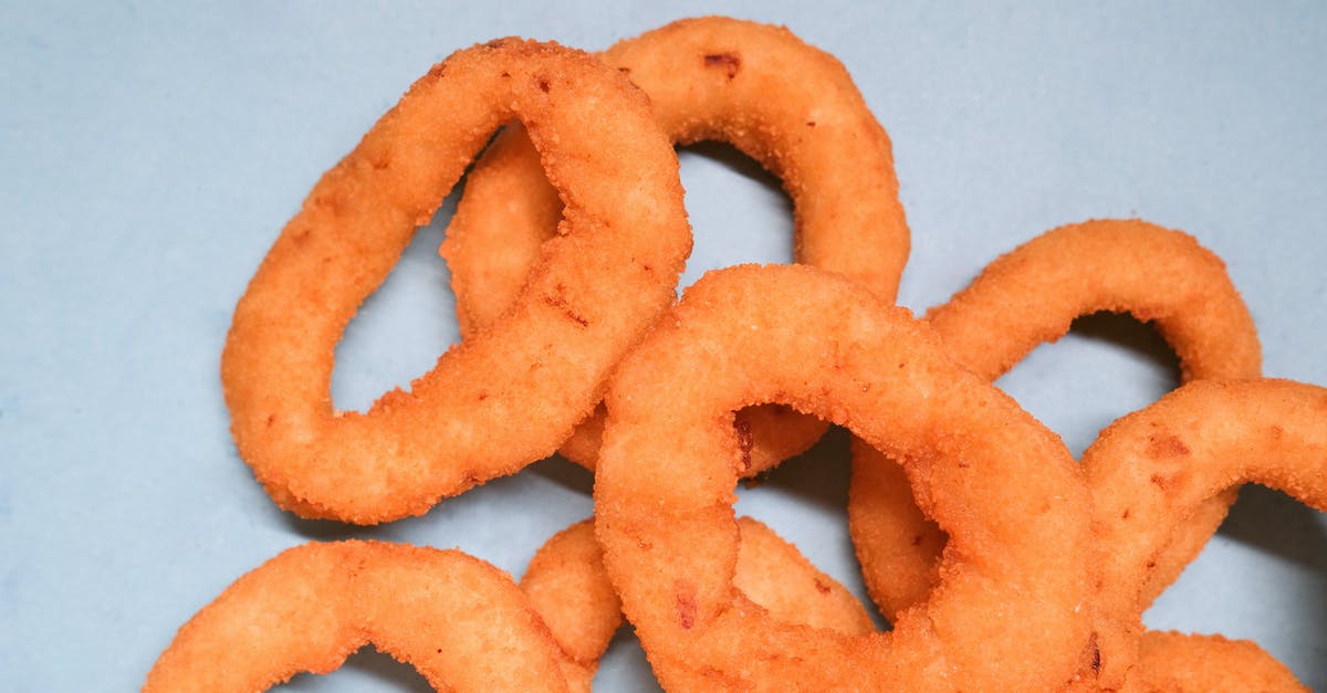 How to get crispy vegetables chips/fries without frying? - Deep fried onion rings on blue background