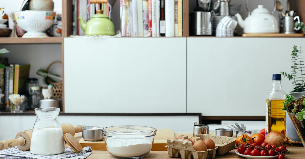 How to get flour quesadilla light and crispy? - Bowl of flour and eggs on table with and tomatoes and olive oil in contemporary light kitchen