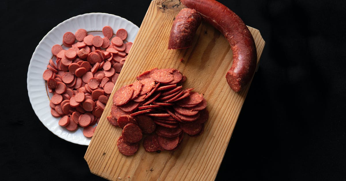 How to get rid of the rich iron and blood taste in certain beef cuts? - From above of slices of meat sausage placed on wooden cutting board and plate on black background How to get rid of the rich iron and blood taste in certain beef cuts? - From above of slices of meat sausage placed on wooden cutting board and plate on black background