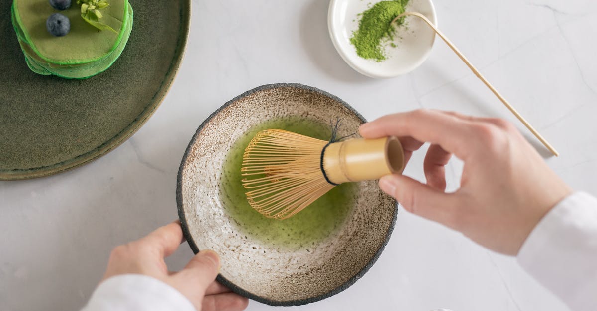 How to I need to treat dried green lentils? [duplicate] - Top view of anonymous cook mixing green food coloring with water using whisk on white table with pancakes