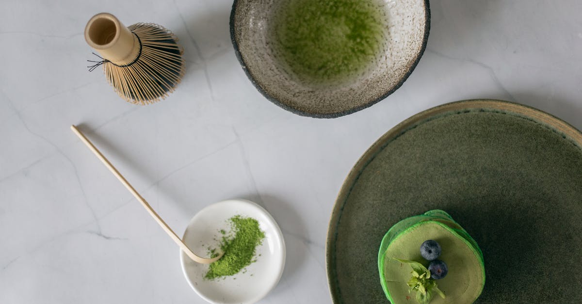 How to I need to treat dried green lentils? [duplicate] - Top view of ceramic bowl with mixed food coloring with water near whisk and platter with stack of delicious pancakes and blueberry