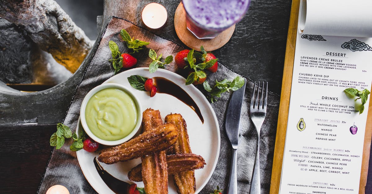 How to keep a green smoothie from getting 'frothy'? - From above of delicious Spanish churros with green dip sauce garnished with fresh strawberries and melted chocolate near glass of blueberry milkshake and menu in restaurant How to keep a green smoothie from getting 'frothy'? - From above of delicious Spanish churros with green dip sauce garnished with fresh strawberries and melted chocolate near glass of blueberry milkshake and menu in restaurant
