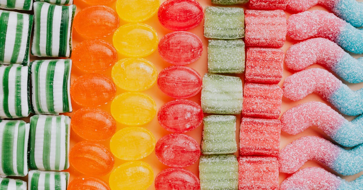 How to keep caramel from hardening prematurely? - From above of various delicious jelly and caramel sweets arranged in rows by type and color in modern candy store How to keep caramel from hardening prematurely? - From above of various delicious jelly and caramel sweets arranged in rows by type and color in modern candy store