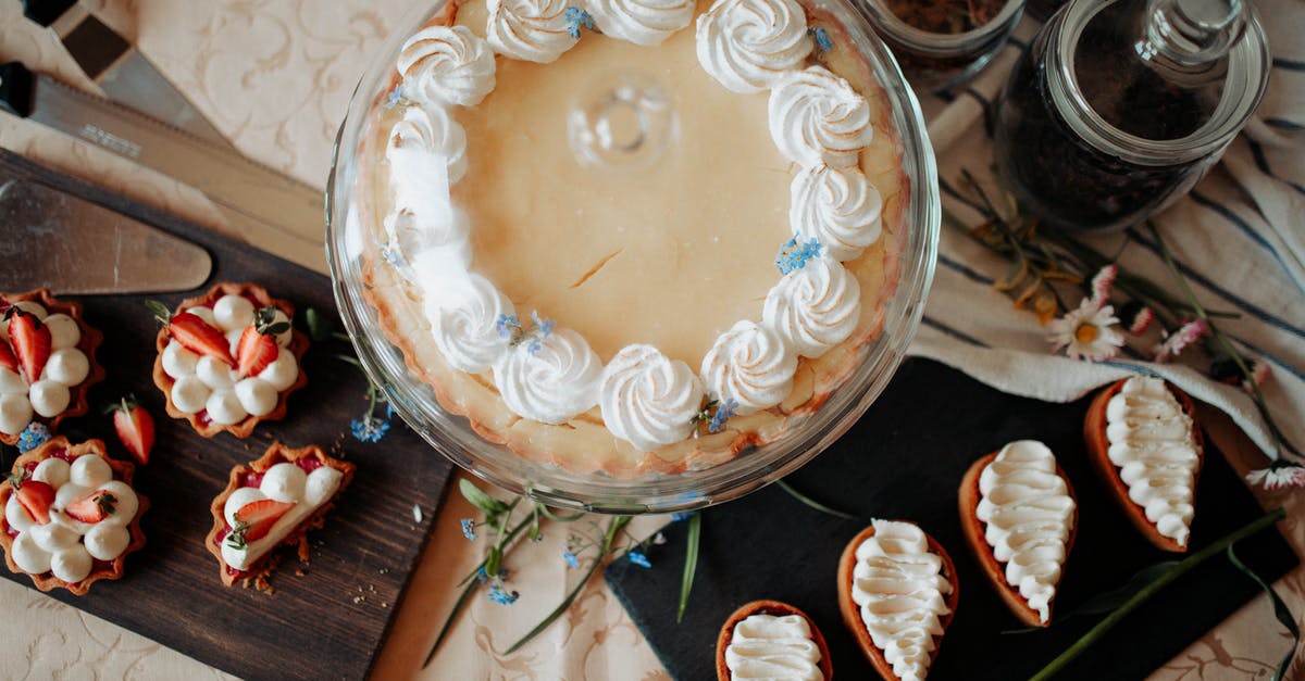 How to make a cover for a molten cake? - Top view of appetizing cake and desserts with whipped cream near knives and flowers on table How to make a cover for a molten cake? - Top view of appetizing cake and desserts with whipped cream near knives and flowers on table
