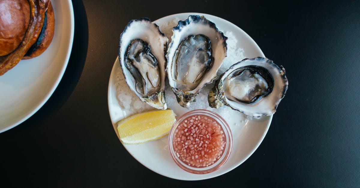 How to make a sauce using sugared citrus rinds? - Top view of sophisticated seafood dish with oysters served on plate with sauce and lemon on table in modern restaurant How to make a sauce using sugared citrus rinds? - Top view of sophisticated seafood dish with oysters served on plate with sauce and lemon on table in modern restaurant