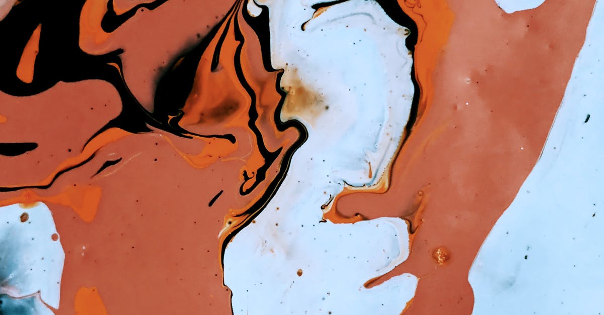 How to make a smooth crème brûlée top - Abstract background of brown spots randomly spread over light blue surface and black spills paint on top