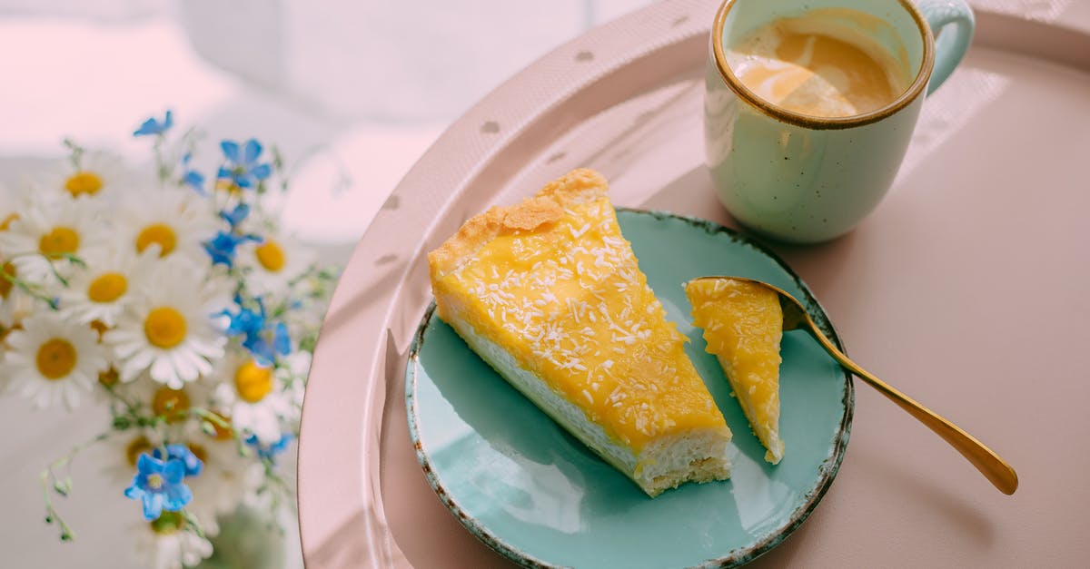How to make a stable culinary Parmesan foam - From above of delicious latte coffee in ceramic mug and slice of cheese cake on plate served on tray and bunch of field flowers on table
