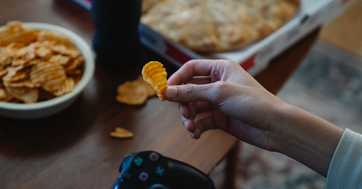 How to make crispy/dry potato chips/crisps? - Crop gamer with potato chip and joystick in room How to make crispy/dry potato chips/crisps? - Crop gamer with potato chip and joystick in room