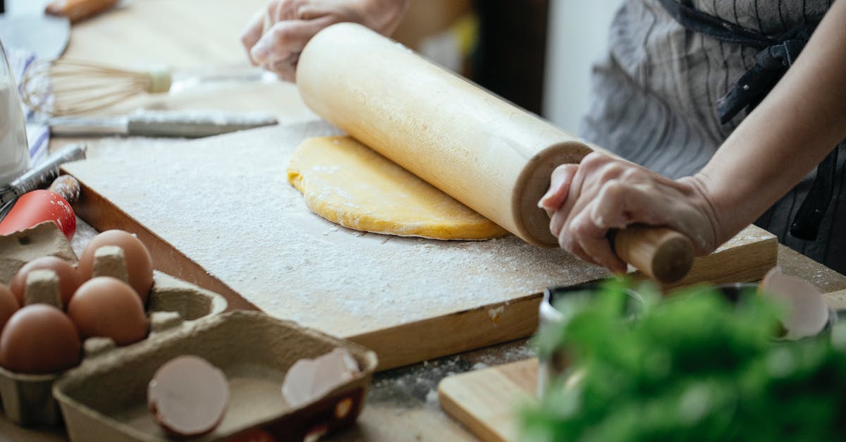 How to make good quality onion powder at home? - Unrecognizable female cook flattening dough with rolling pin while standing at table with wooden board against blurred background in kitchen How to make good quality onion powder at home? - Unrecognizable female cook flattening dough with rolling pin while standing at table with wooden board against blurred background in kitchen