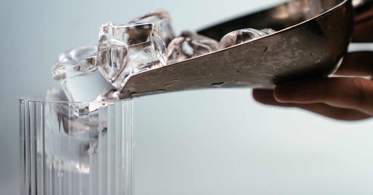 How to make large clear ice cubes - Person Holding Clear Glass Mug How to make large clear ice cubes - Person Holding Clear Glass Mug