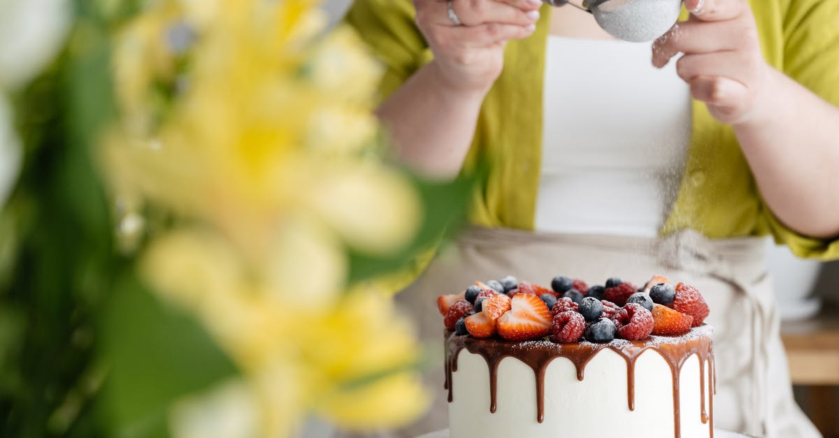 How to Make Nutella Icing without Powdered Sugar - Crop female baker strewing powdered sugar to decorated cake How to Make Nutella Icing without Powdered Sugar - Crop female baker strewing powdered sugar to decorated cake