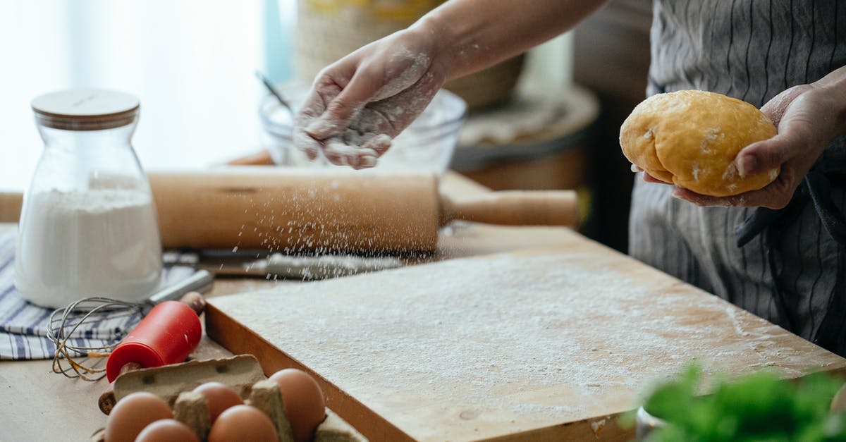 How to make oil have powder garam masala taste? - Crop faceless female baker in apron sprinkling wheat flour on cutting board to roll out fresh dough in modern kitchen How to make oil have powder garam masala taste? - Crop faceless female baker in apron sprinkling wheat flour on cutting board to roll out fresh dough in modern kitchen