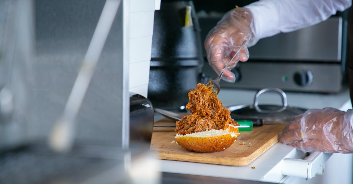 How to make professional style burger buns? - Cook putting fried pork on bun for burger How to make professional style burger buns? - Cook putting fried pork on bun for burger
