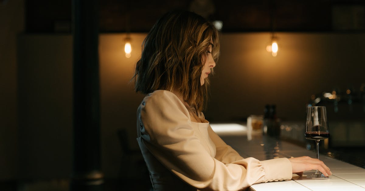 How to make red wine sauce? - Woman in White Long Sleeve Shirt Sitting by the Table How to make red wine sauce? - Woman in White Long Sleeve Shirt Sitting by the Table