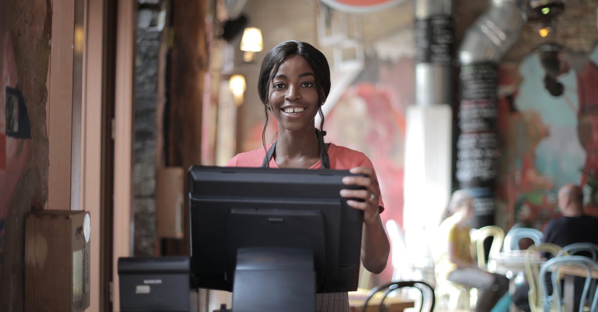 How to make restaurant style poppadoms - Positive young woman in uniform smiling while standing at counter desk in cafe How to make restaurant style poppadoms - Positive young woman in uniform smiling while standing at counter desk in cafe