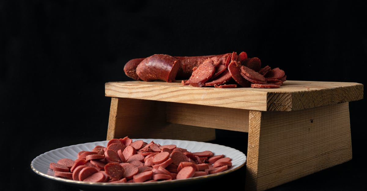 How to make round Seitan sausages - Delicious cut sausages on cutting board and plate How to make round Seitan sausages - Delicious cut sausages on cutting board and plate
