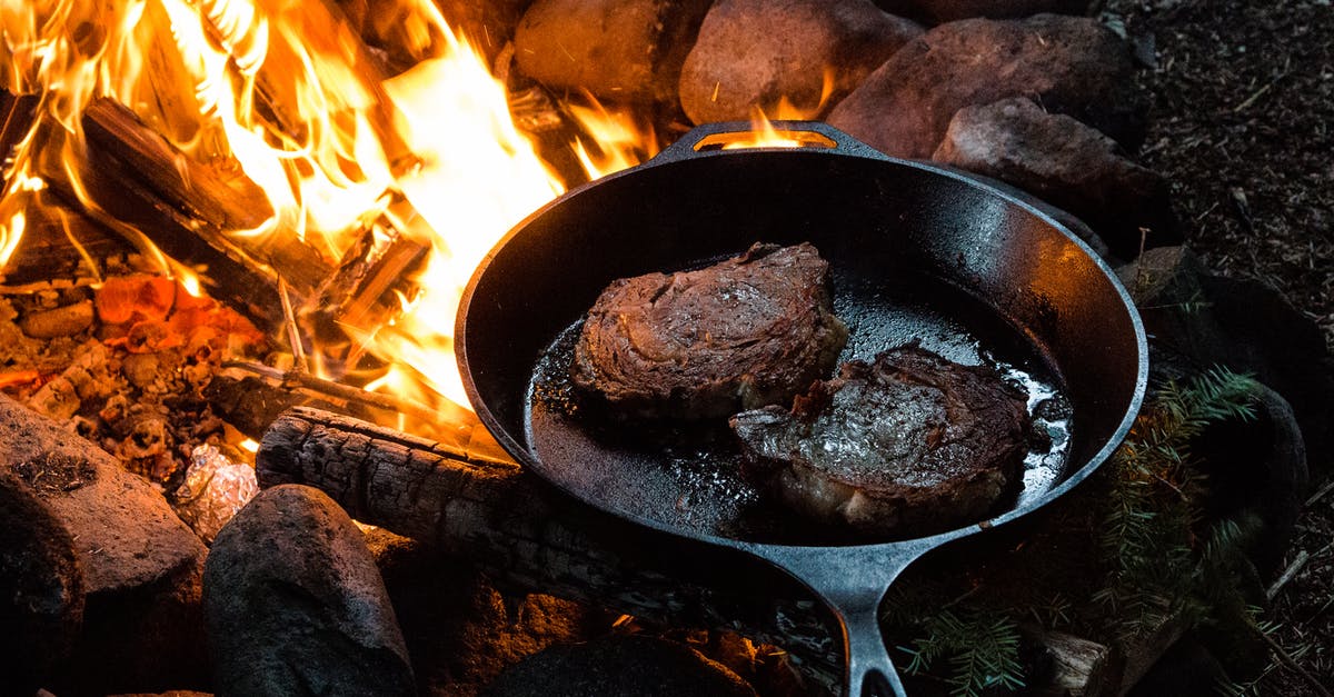 How to make the best of tough meat while camping? - A Frying Pan with Two Slices of Steak on Campfire How to make the best of tough meat while camping? - A Frying Pan with Two Slices of Steak on Campfire