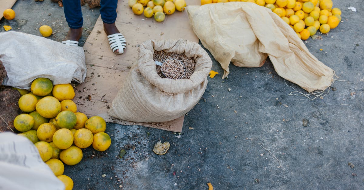How to make the legs of a whole roasted duck less fatty? - From above of crop faceless seller near pile of ripe oranges on ground and bag of grains at bazaar How to make the legs of a whole roasted duck less fatty? - From above of crop faceless seller near pile of ripe oranges on ground and bag of grains at bazaar