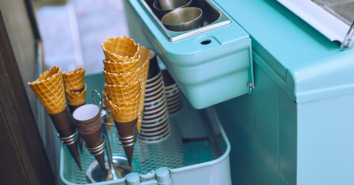 How to make wafer paper? - From above of light blue ice cream cart equipped with metal glasses with scoop above basket with waffle cones and paper cups How to make wafer paper? - From above of light blue ice cream cart equipped with metal glasses with scoop above basket with waffle cones and paper cups