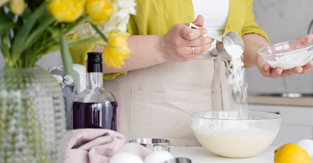 How to measure egg boiling time? - Crop woman pouring flour in bowl in kitchen How to measure egg boiling time? - Crop woman pouring flour in bowl in kitchen