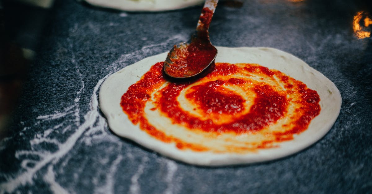 How to measure tomatoes for making sauce? - Close-Up Shot of Person Spreading Tomato Sauce onto Pizza Dough How to measure tomatoes for making sauce? - Close-Up Shot of Person Spreading Tomato Sauce onto Pizza Dough
