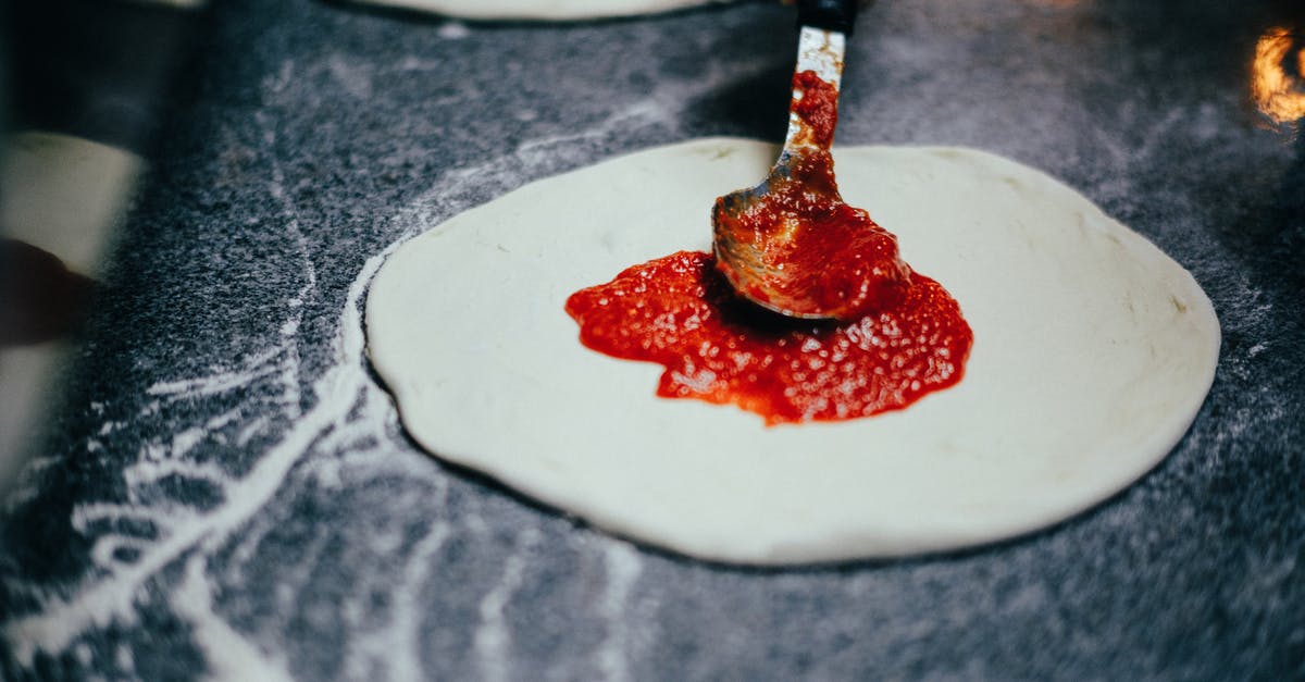 How to measure tomatoes for making sauce? - Close-Up Shot of Person Spreading Tomato Sauce onto Pizza Dough How to measure tomatoes for making sauce? - Close-Up Shot of Person Spreading Tomato Sauce onto Pizza Dough