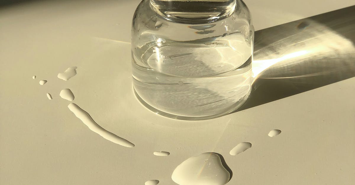 How to pack items that may leak liquids for lunch? - Glass jar with transparent liquid placed on white table How to pack items that may leak liquids for lunch? - Glass jar with transparent liquid placed on white table