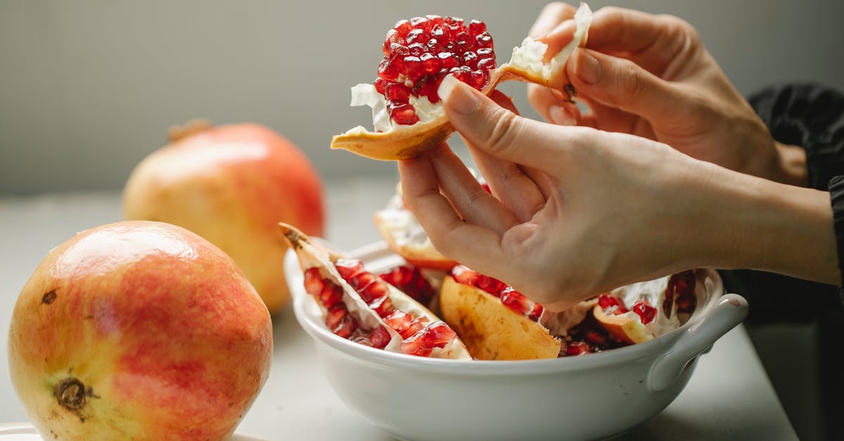 how to peel a pomegranate efficiently? - Woman taking off peel from ripe pomegranate how to peel a pomegranate efficiently? - Woman taking off peel from ripe pomegranate
